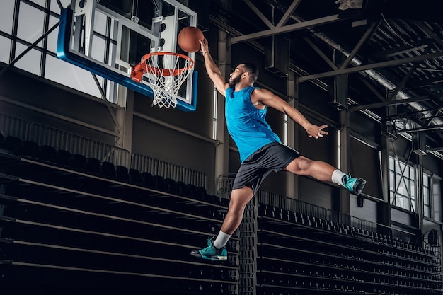 Black professional Black basketball player in action in a basketball court.