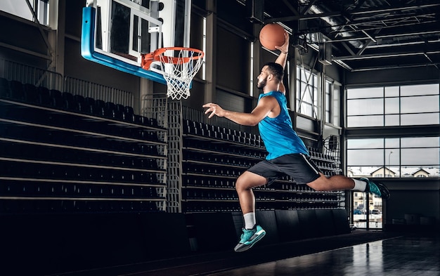 Black professional Black basketball player in action in a basketball court.