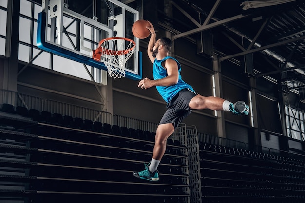 Black professional Black basketball player in action in a basketball court.