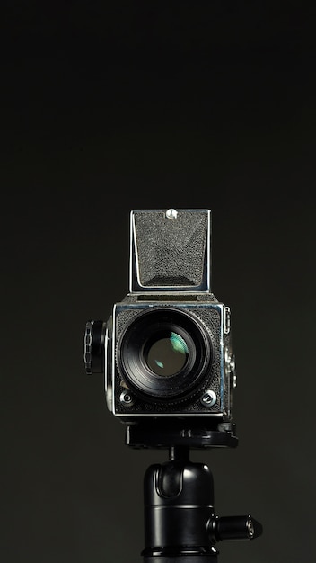 Black professional camera in a minimalist studio