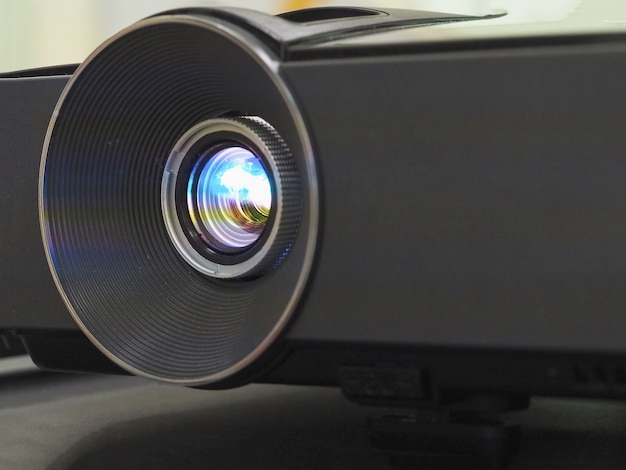 Black projector on black table, close up.