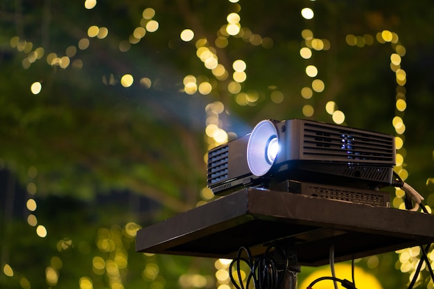 Black Projector on stand table ready for presentation in yellow 