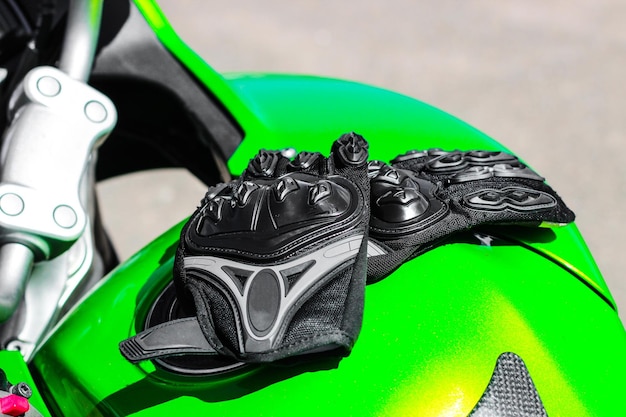 Black protective gloves for a motobiker with plastic inserts