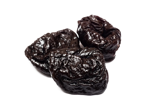 Black prune close up isolated on white background