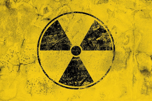 Black radioactive sign over yellow background