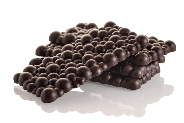 Black raw chocolate stack of bars on a white background. Isolate.