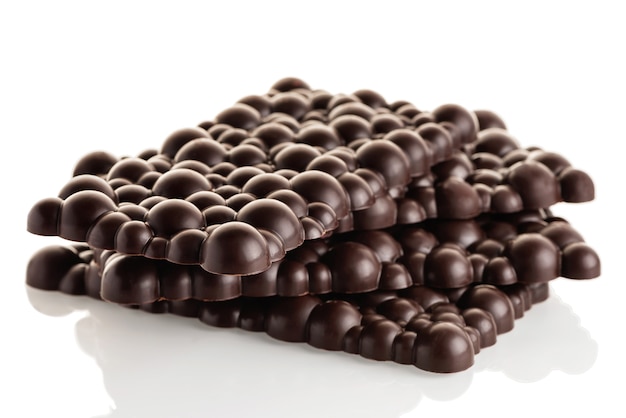 Black raw chocolate stack of bars on a white background. Isolate.