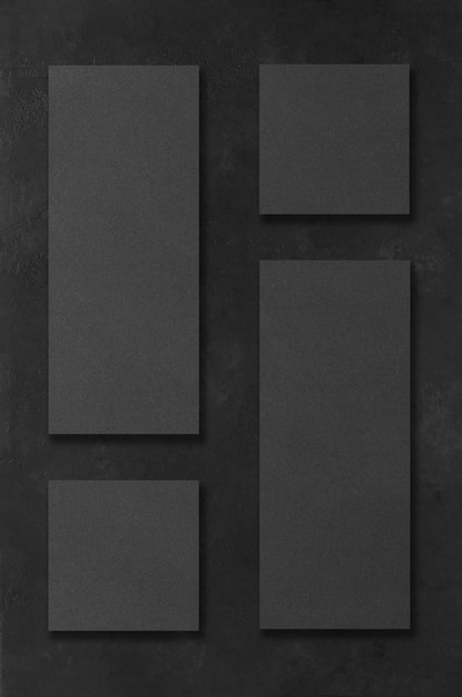 Black rectangular mockups on a dark concrete background. Design elements or portfolio. Copy space.