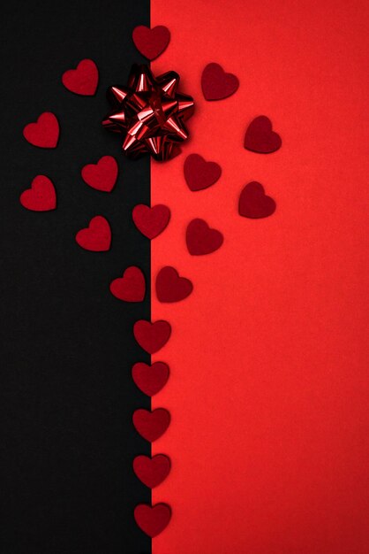 Black and red background decorated with a red bow and red hearts, a banner for discounts or congratu