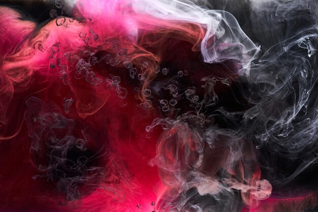 Black and red ink background colorful fog abstract swirling ocean acrylic paint pigment underwater white smoke