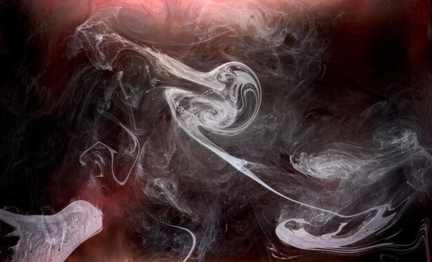 Photo black and red ink background colorful fog abstract swirling ocean acrylic paint pigment underwater white smoke