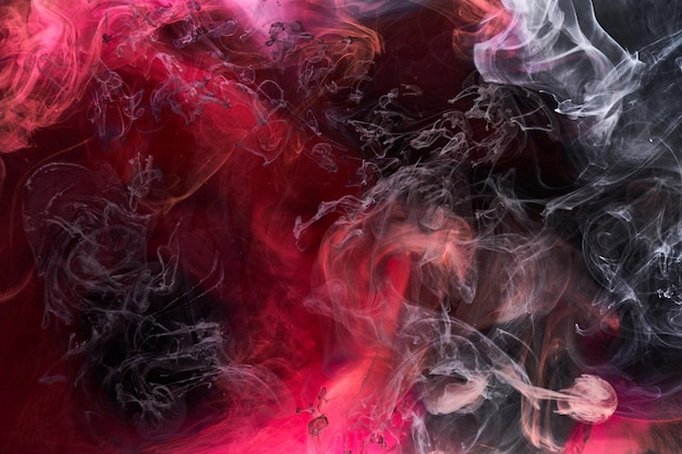 Black and red ink background colorful fog abstract swirling ocean acrylic paint pigment underwater white smoke