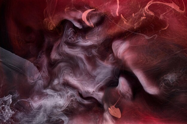 Black and red ink background colorful fog abstract swirling ocean acrylic paint pigment underwater white smoke