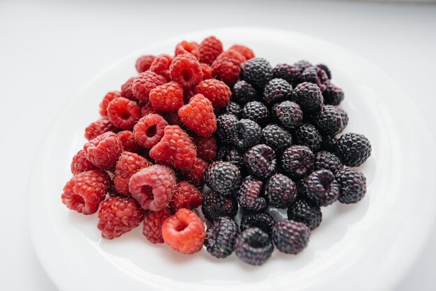 Black and red raspberry close-up on a white background