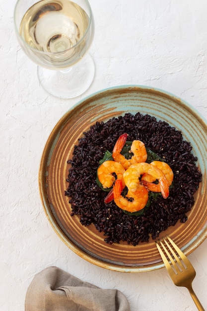 Photo black rice risotto with shrimp.