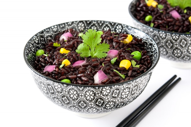 Black rice and vegetables isolated on white