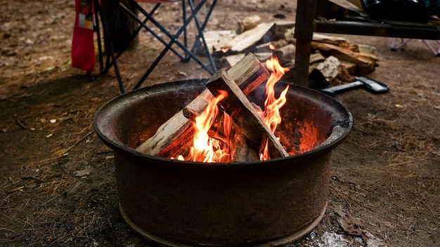 Black round Barbecue Grill with Fire on Open Air with green grass Fire Flame