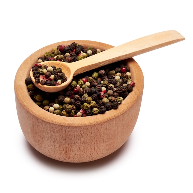 Black round pepper spice in wooden bowl or mortar on white surface