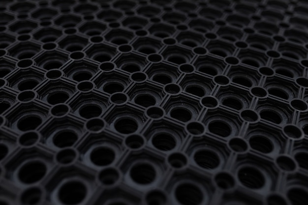 Photo black rubber floor mat close-up.