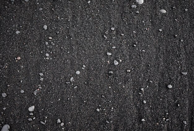 Photo black sand as a background in the iceland sea shore abstract composition design image