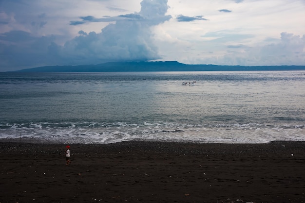 Black sand beach on sunset on Bali island Indonesia