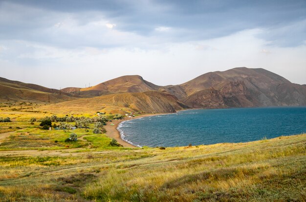 The black sea coast in the Crimea, in Koktebel on the Cape Chameleon at sunset