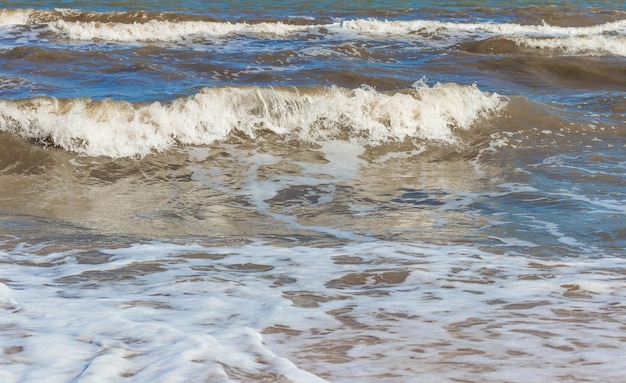 The Black Sea in sunny weather Surf on the beach wavessandy shore