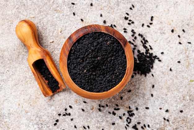 Black sesame seeds in wooden bowl