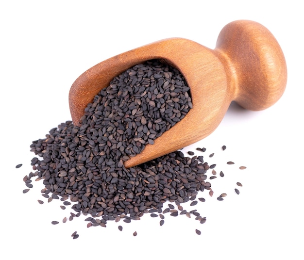 Black sesame seeds in wooden scoop isolated on white background Organic spice