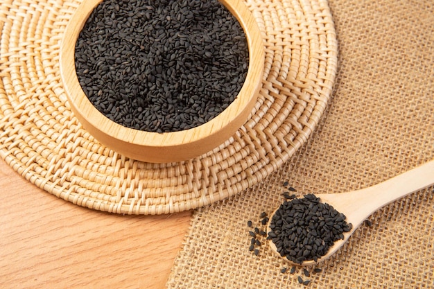 black sesame in wooden spoon and bowlclose up and choose a focus point