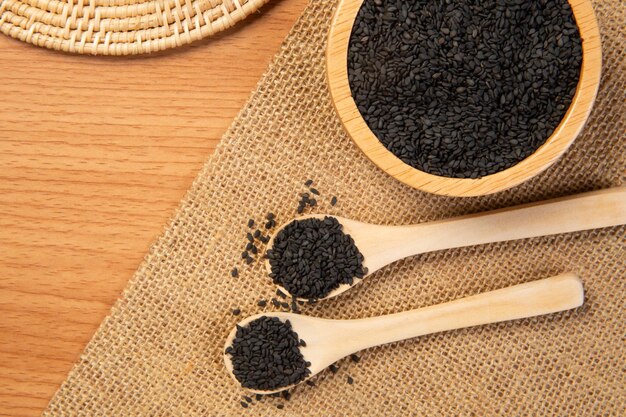 Black sesame in wooden spoon and bowlclose up and choose a focus point