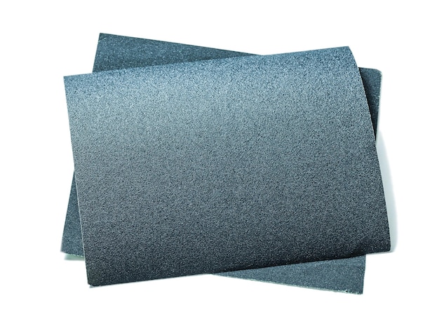 Black sheets of abrasive paper isolatedon white