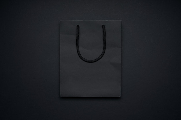 Black shopping bag mockup display on black background