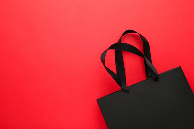 Black shopping bag on a red .