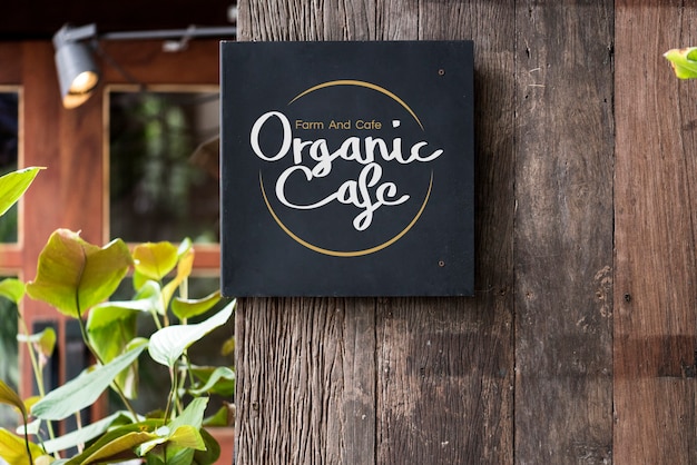 Photo black signage on a rustic wooden wall mockup