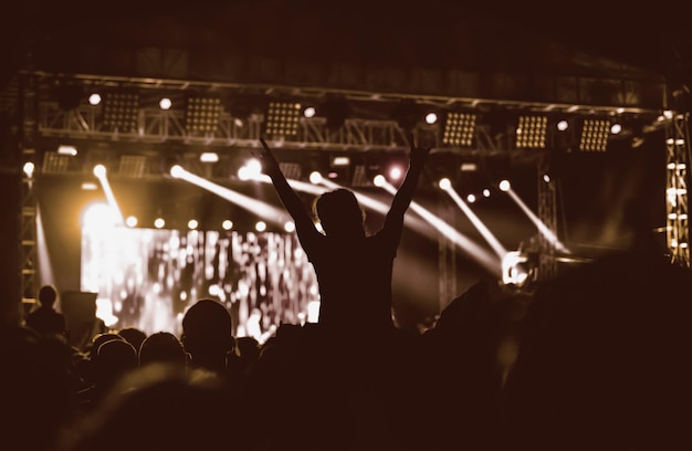 Black silhouette of young girl on rock concert