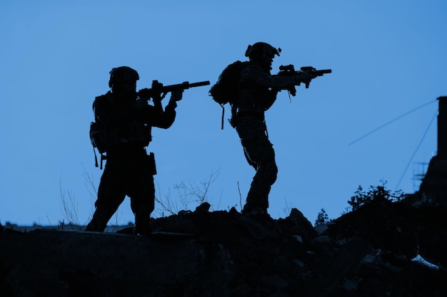 Black silhouettes of pair of soldiers