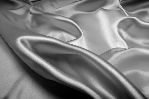 Photo black silk texture luxurious satin for abstract background dark tone of fabric