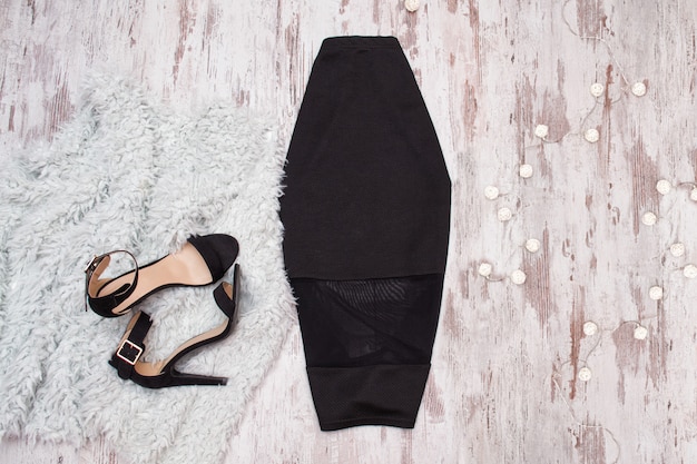 Black skirt and shoes on wooden