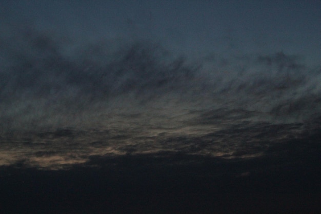 空に白い雲のある黒い空