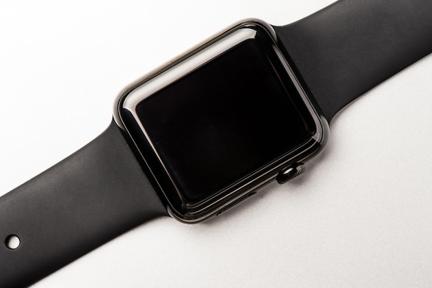 Black smart watch located on a white background