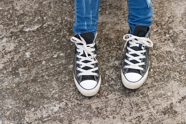 Black Sneakers shoes on road concrete