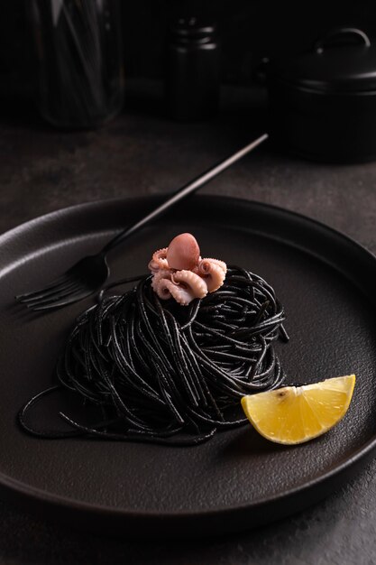 Black spaghetti with cuttlefish ink with boiled octopus