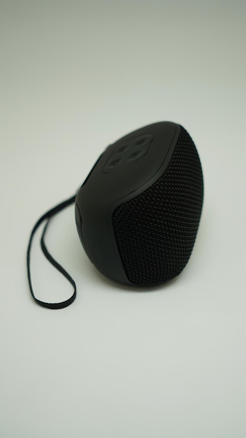 A black speaker with a cord attached to it