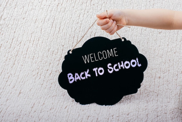 Black speech bubble shaped notice board in hand