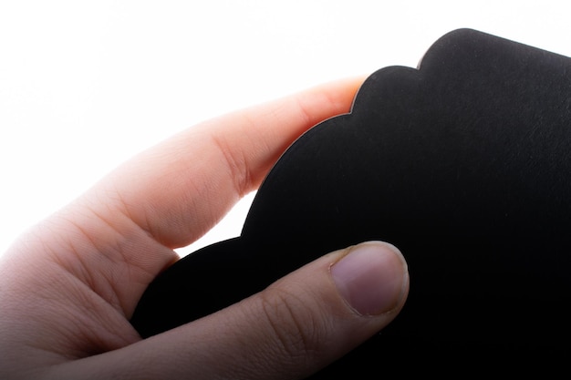 Black speech bubble shaped notice board in hand