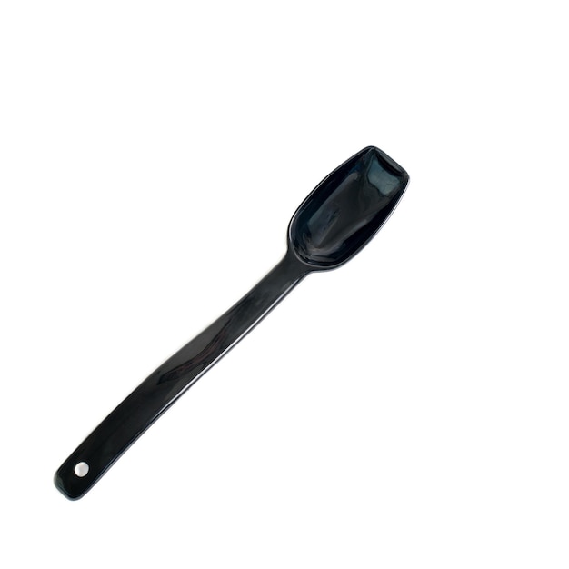 A black spoon for loose materials in the kitchen on an insulated white background