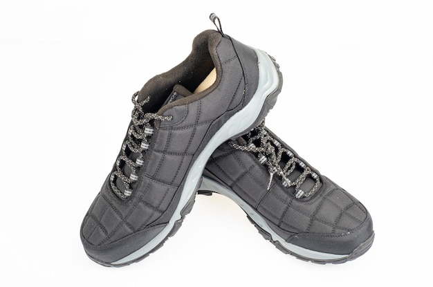 Black sports insulated shoes on white background. Studio Photo.