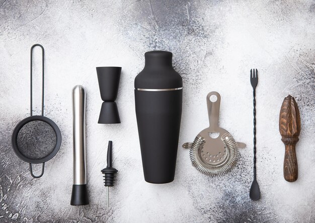 Photo black and stainless steel shaker pourer spoon strainer muddler and jigger