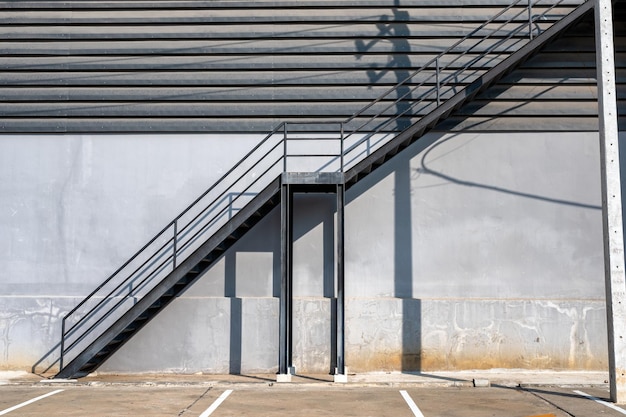 Black steel stair fire escape and car park at warehouse\
distribution